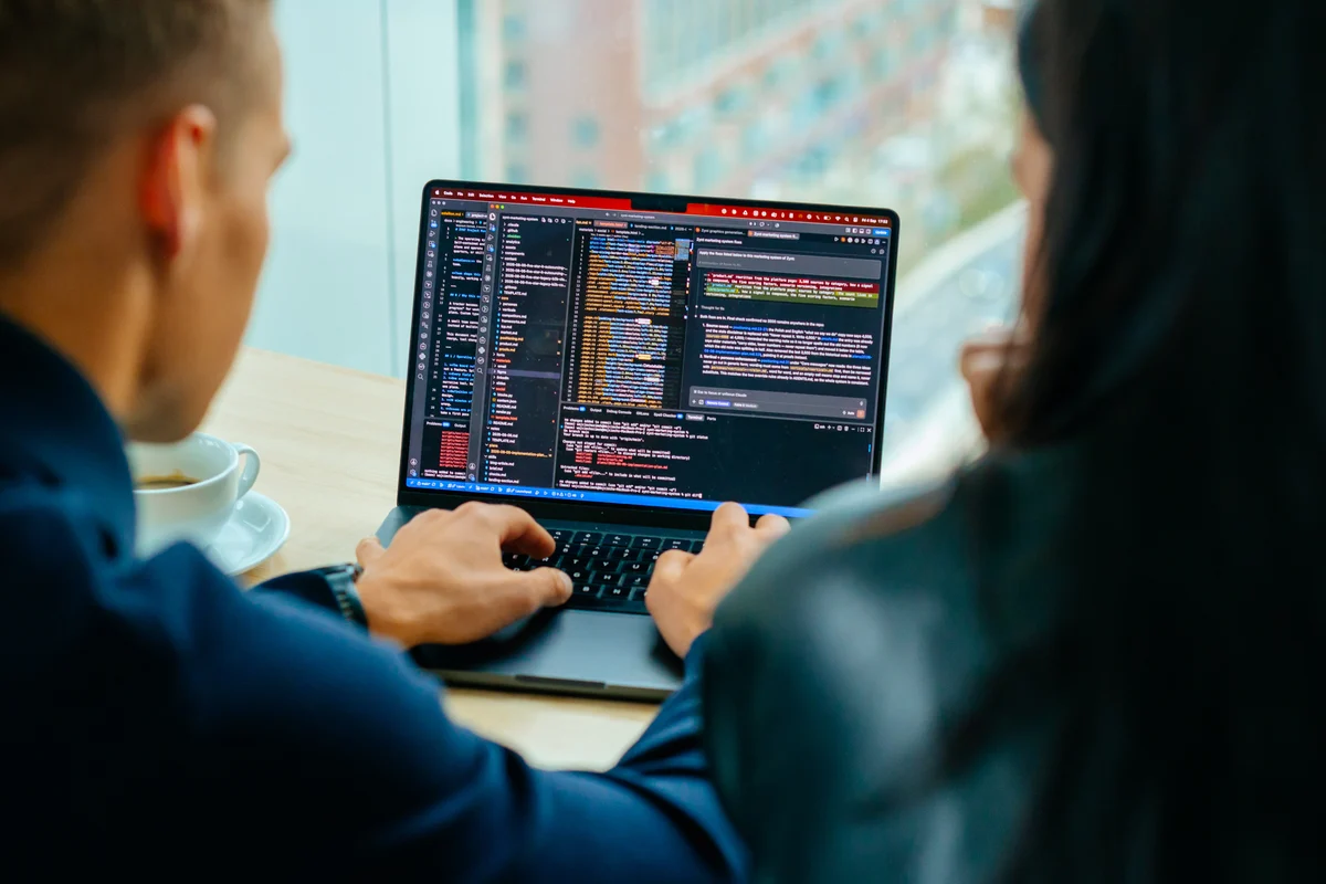 Two GTM builders working side by side on a laptop with Codex.
